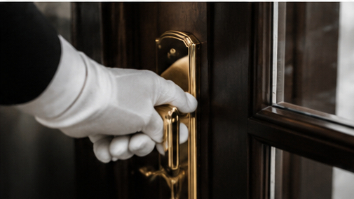 White-gloved hand at a residence door